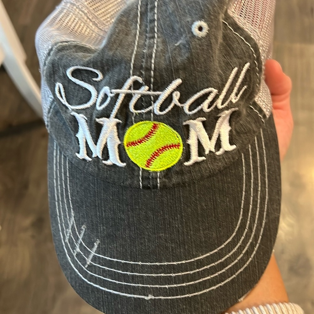 Baseball cap says Softball Mom and is dark gray and light gray color